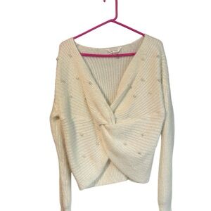 Elegant Cream Sweater with Twist Detail and Pearl Accents
